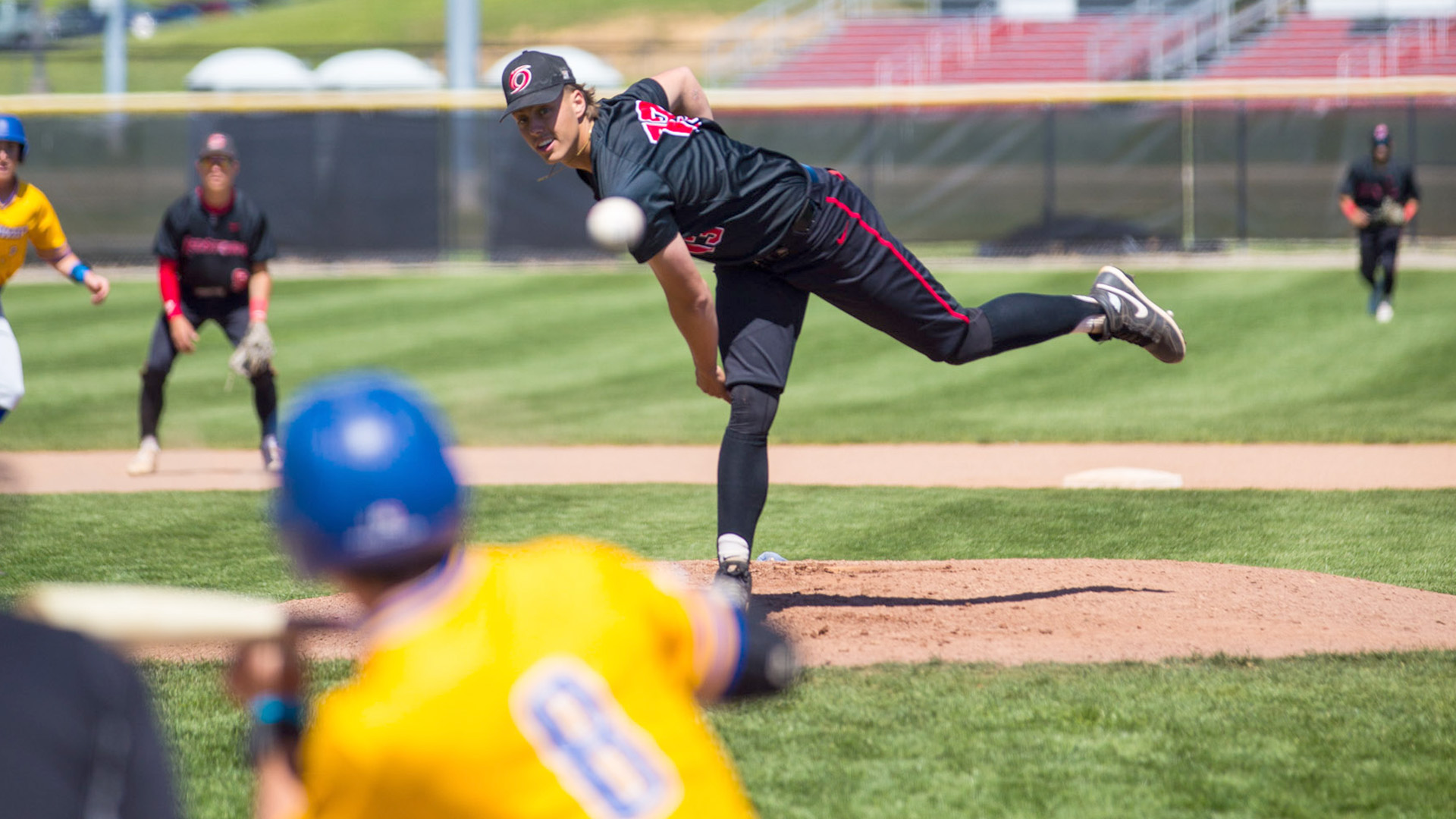 Rio Grande freshman KB Perkins fires a pitch plateward during Saturday's first game against Midway University at Bob Evans Field. The RedStorm swept the twin bill from the Eagles.
