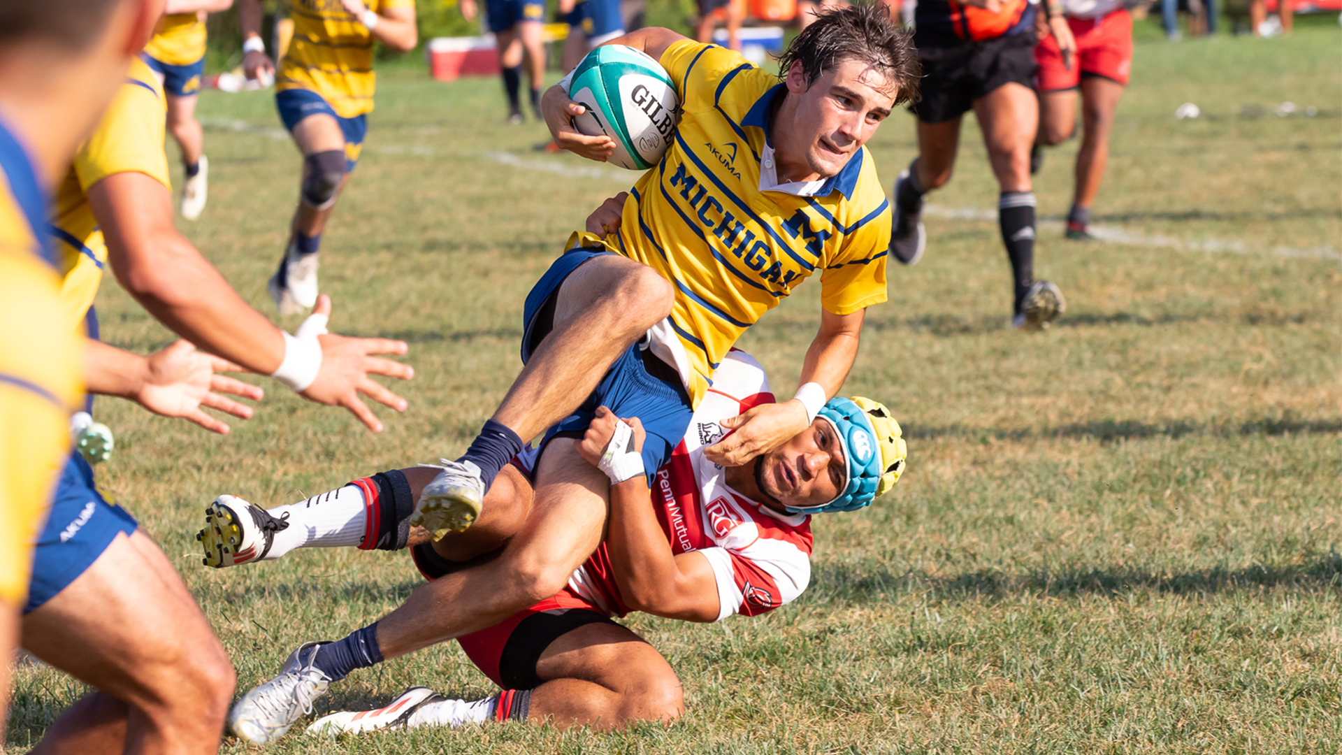Rio Grande's Che Spiotti tackles a Michigan ball carrier during Friday evening's 34-24 win over the Wolverines at Red Valley Pitch.