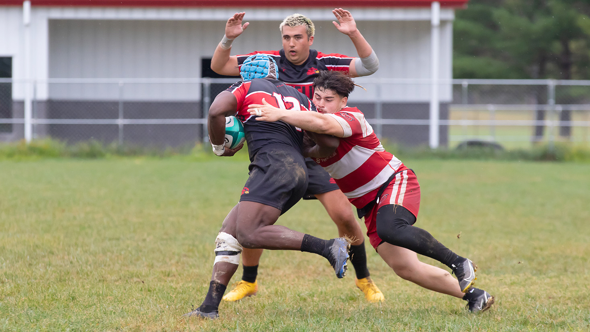 Rio Grande's Isaac Madrid attempts to tackle Wheeling University's Alex Nyamunda during Saturday's non-conference matchup at Red Valley Pitch. The Cardinals defeated the RedStorm, 47-13.