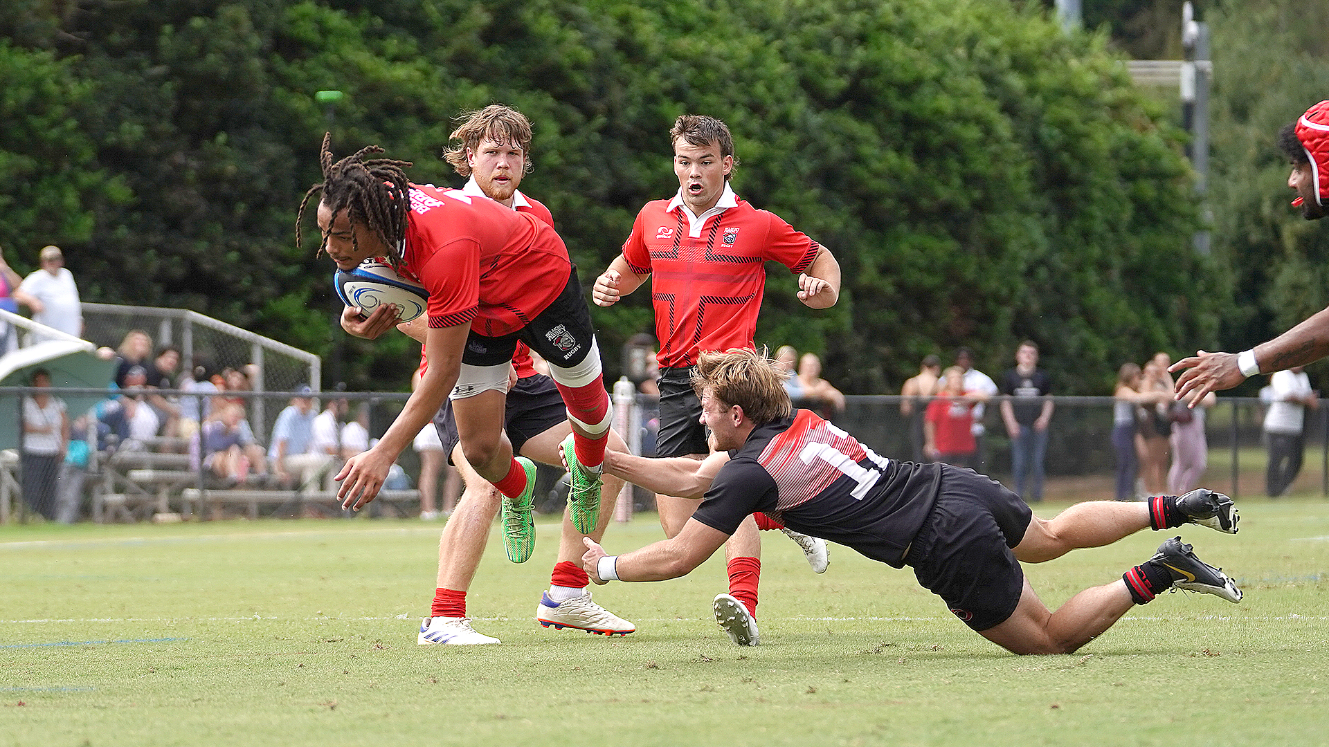 Rio Grande's Will Spencer trips up a Belmont Abbey ball carrier during Friday afternoon's match at Alumni Field in Belmont, N.C. The host Crusaders defeated the RedStorm, 39-17.