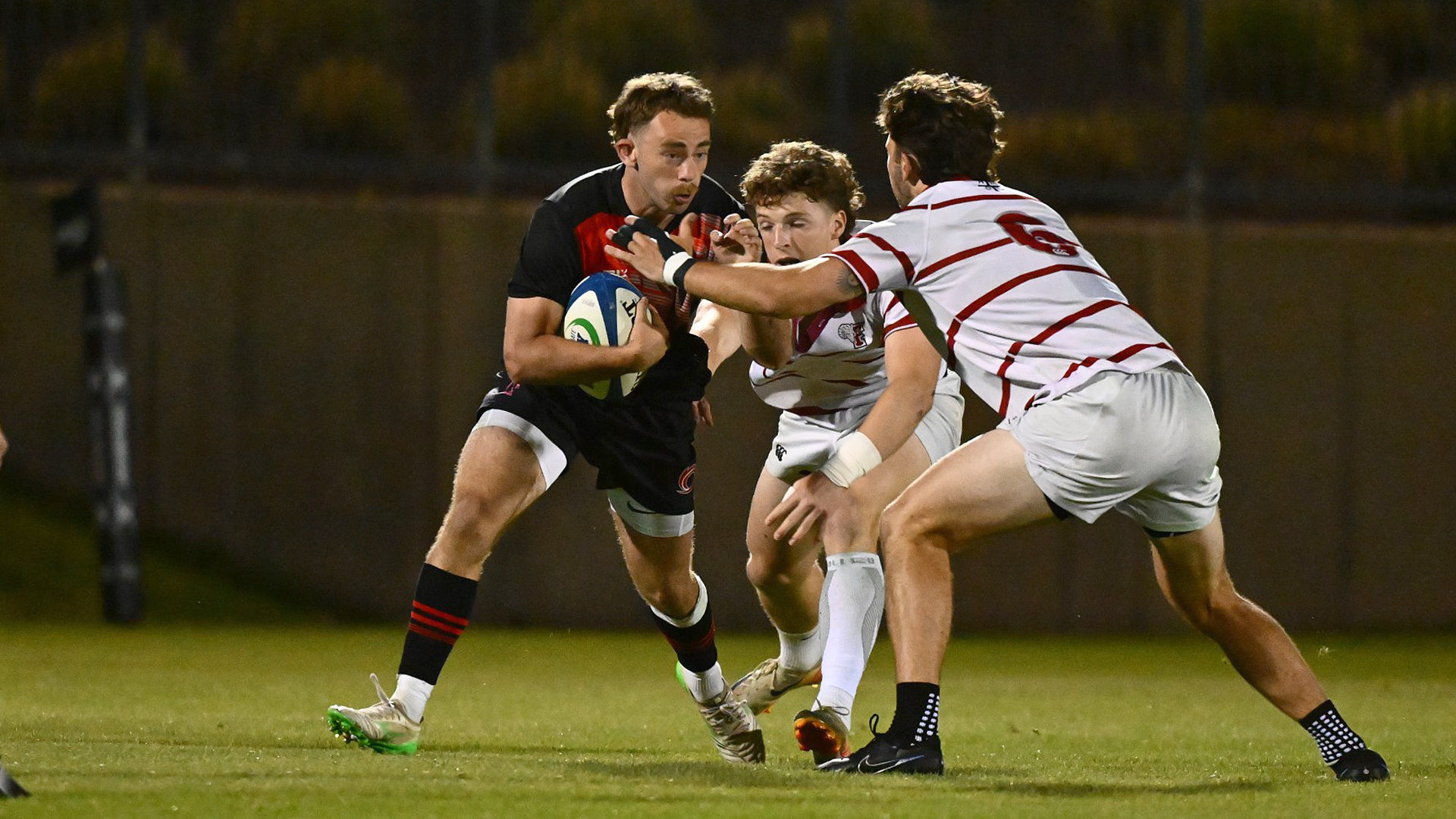 Rio's Thibault Carrere tries to avoid a pair of Fordham defenders during Friday night's action in the Collegiate Rugby Championship National 7s in Boyds, Md.