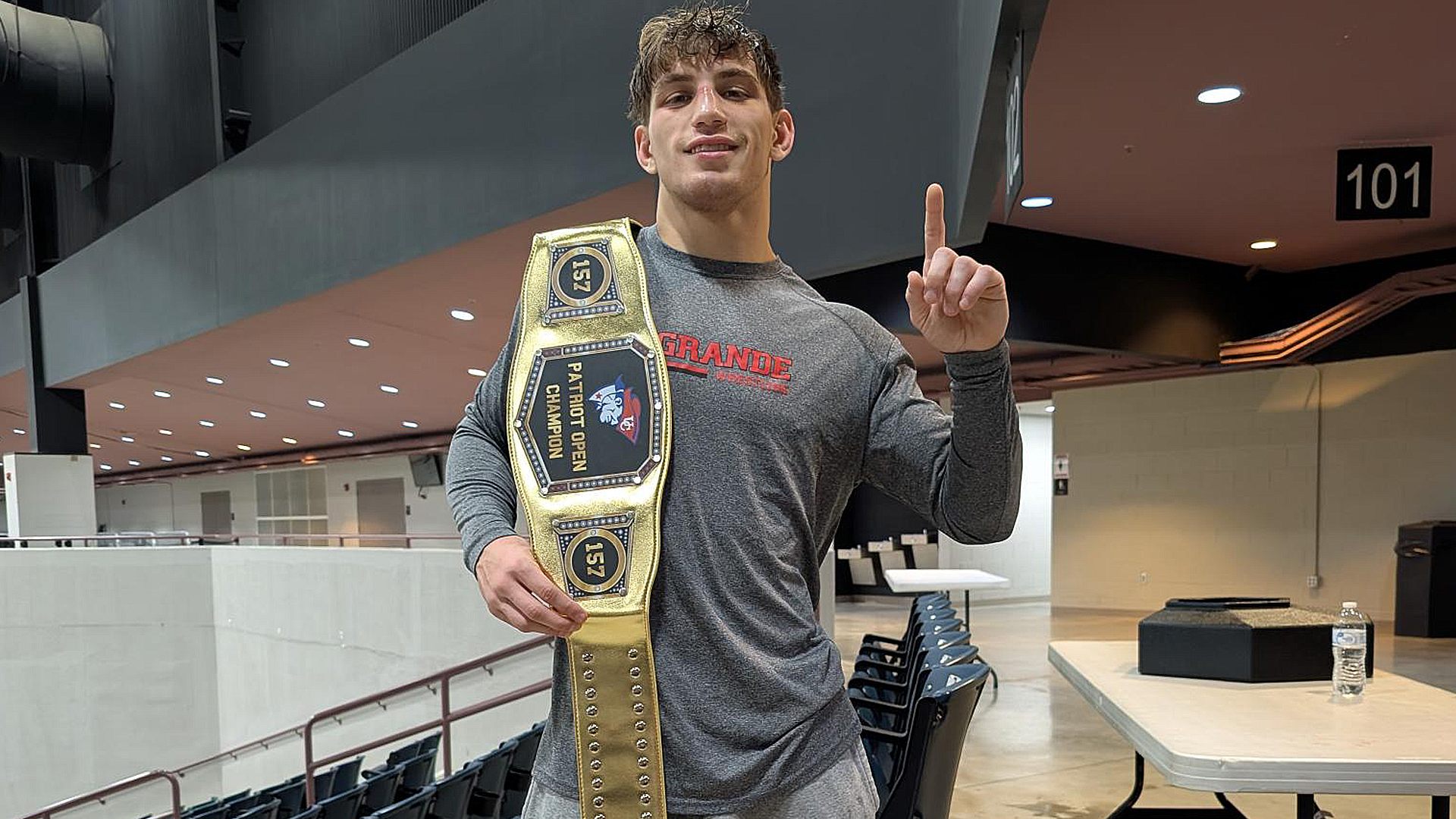 Rio Grande's Westyn Moyer shows off his championship belt after winning the championship in the 157-pound Open division of Saturday's Pepsi Patriot Open.