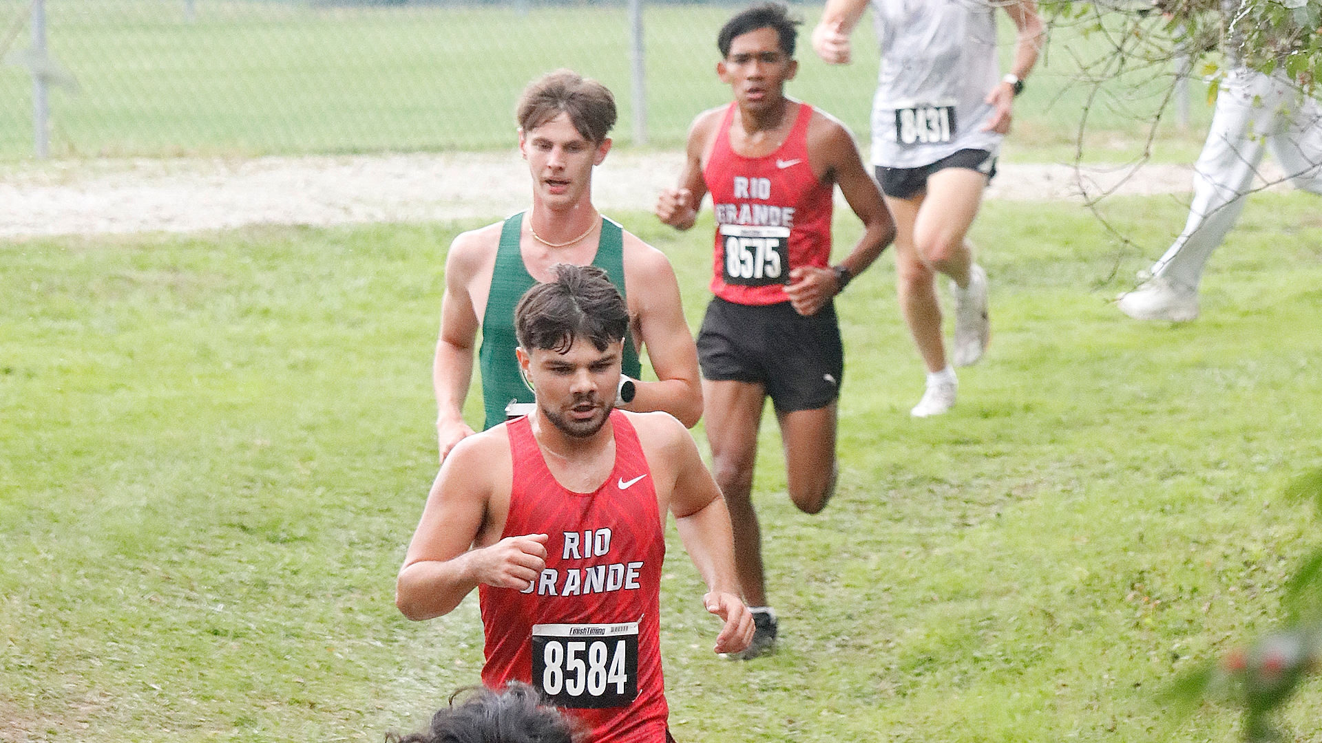 Rio Grande's Wyatt Webb (foreground) and Angel Montes (background) run for the RedStorm in Friday's Jenna Strong Classic at Wilmington College.