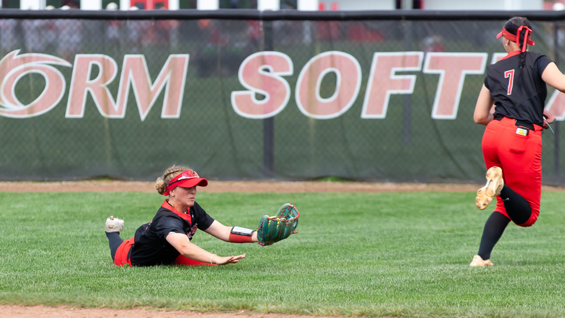 Rio Grande's Emily Lane makes a diving catch while teammate Lindzie Runions runs away to avoid a collision during Friday's game one loss to Brescia at Rio Softball Park.
