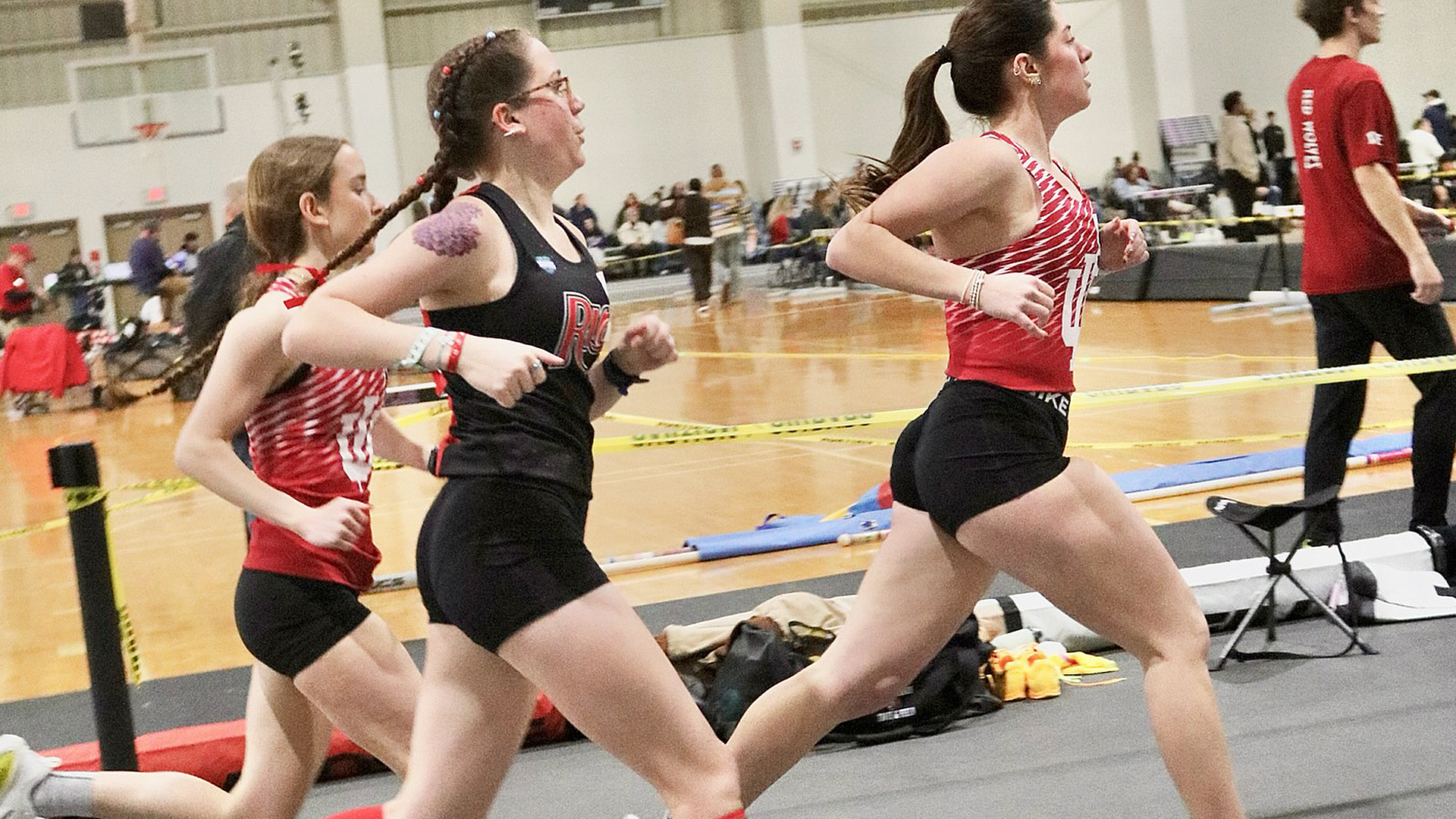 Rio Grande's Josie Hancock (black uniform) competes in the mile run at Saturday's George Glass Indoor Invitational in Upland, Ind.
