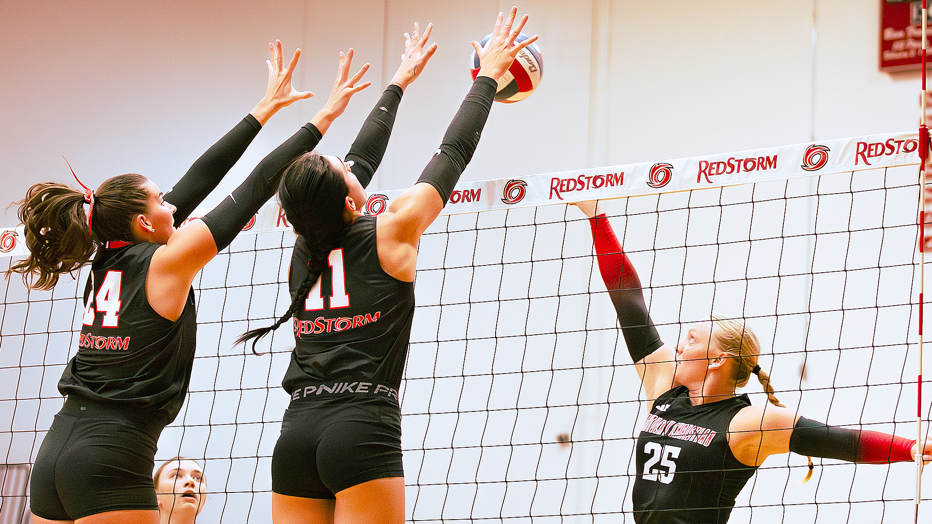 Rio Grande's Averie Bruce (24) and Elle McLoughlin (11) extend their arms in an attempt to block a Kentucky Christian attack during Friday night's straight sets win over the Knights at the Newt Oliver Arena.
